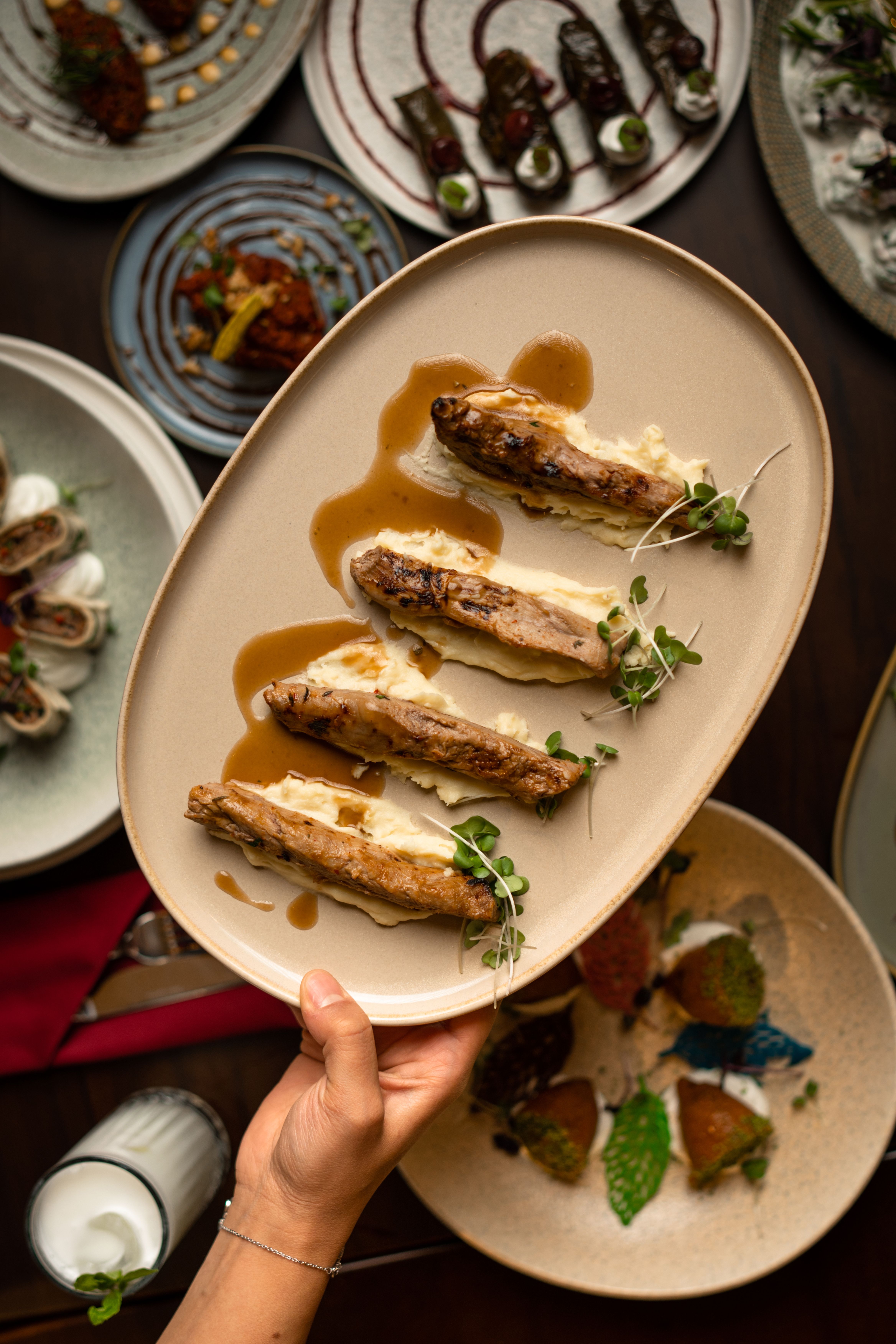 Top view of elegant gourmet chicken dish served with sauce and microgreens on a plate.