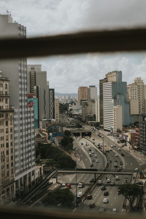 Free Aerial view of Sao Paulo's bustling streets and modern skyscrapers under cloudy skies. Stock Photo