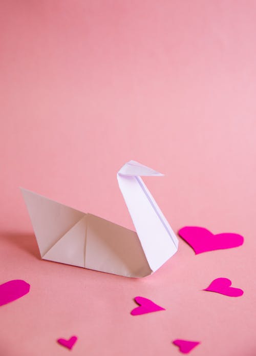 Белый бумажный кораблик на бумаге "Розовое сердце"