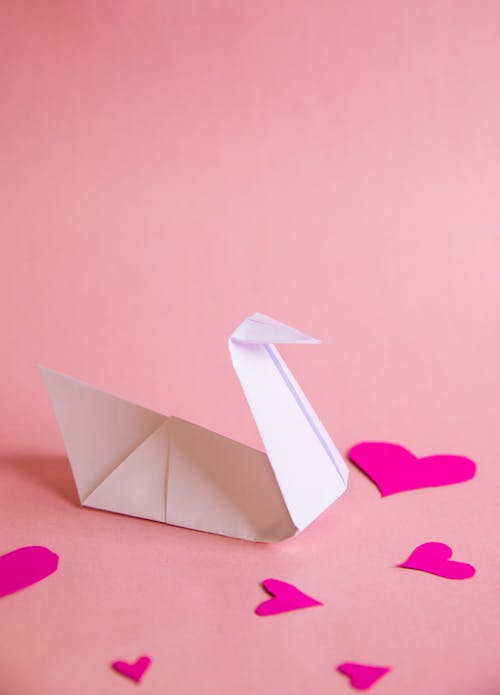 Free White Paper Boat on Pink Heart Paper Stock Photo