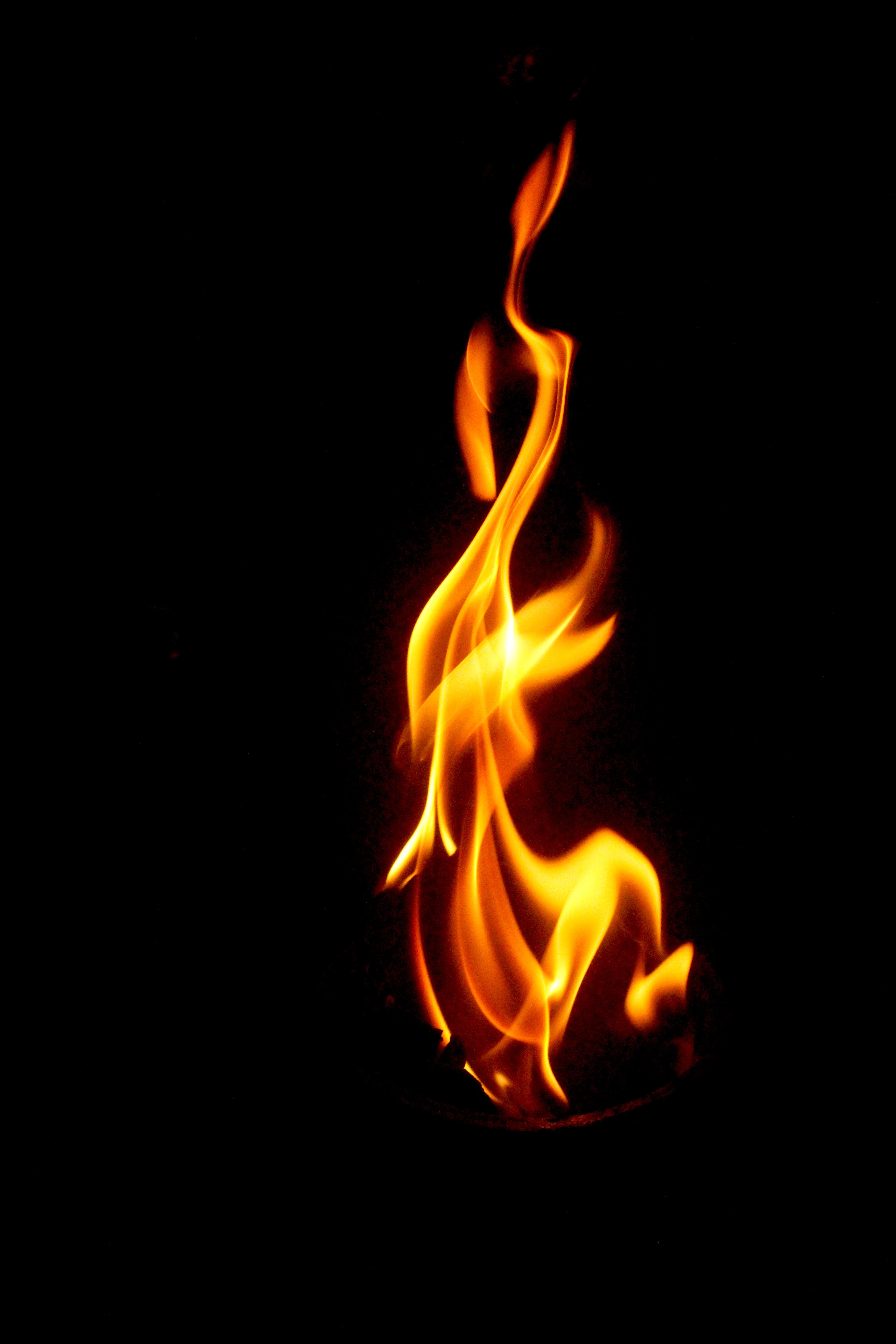 A striking flame dances against a black background, creating a mesmerizing contrast.