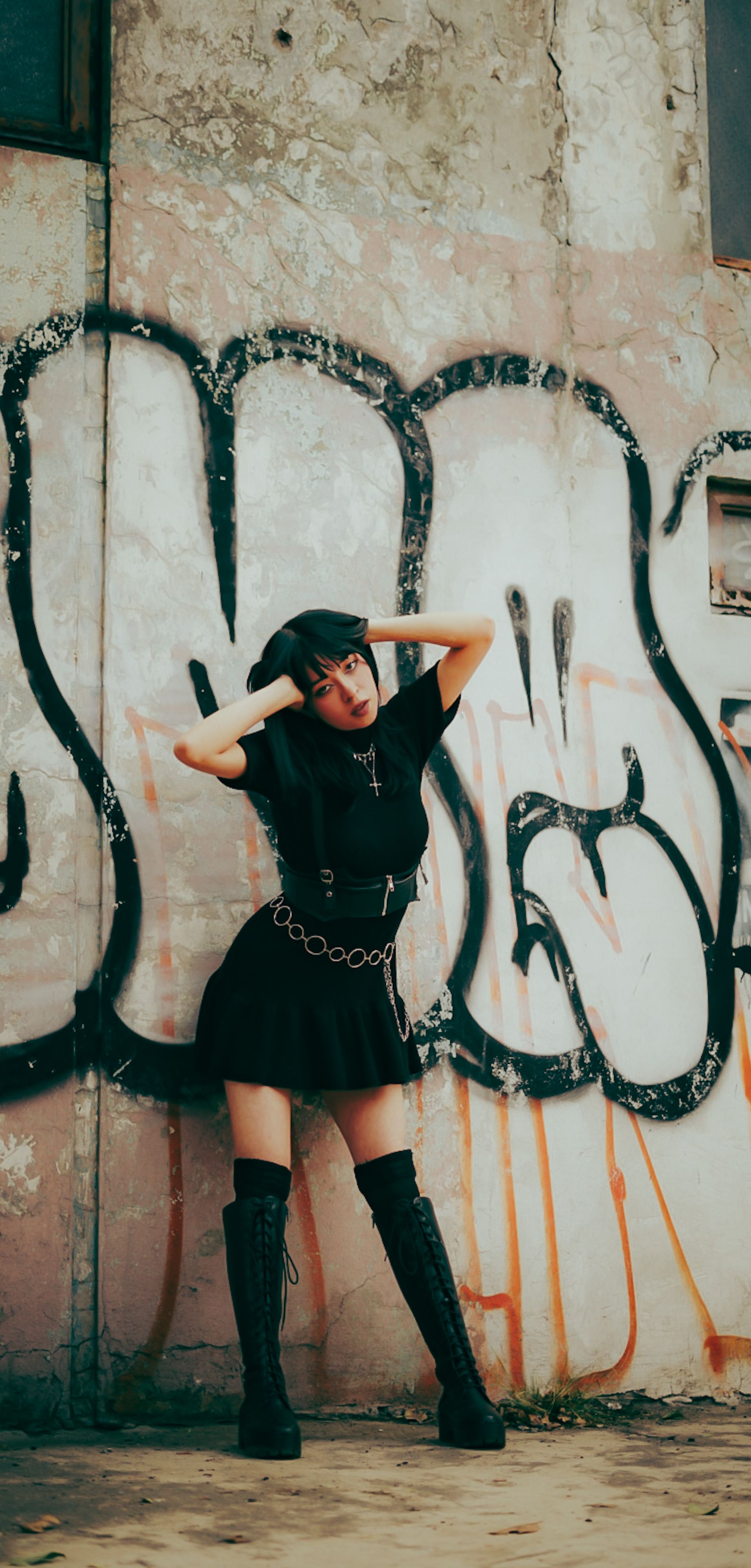 urban fashion portrait with graffiti backdrop