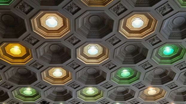 Elegant octagonal ceiling with multicolored lights creating a vibrant and artistic atmosphere.