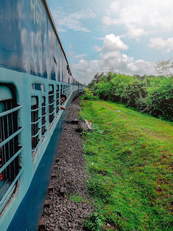 Free Ethnic person looking out of train window Stock Photo