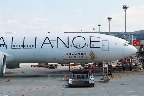 Free Singapore Airlines airplane parked at an airport gate ready for departure. Stock Photo