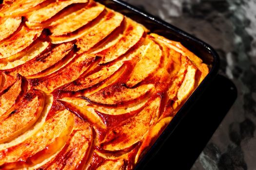 Delicious homemade apple cinnamon cake fresh from the oven, showcasing golden baked apple slices.