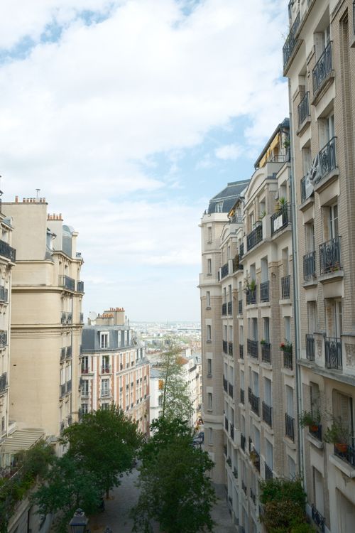 Free A picturesque view of a traditional Parisian street with beautiful architecture. Stock Photo