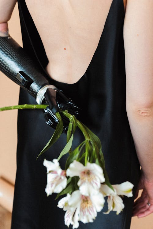 Woman in Black Slip Dress Holding White Flower