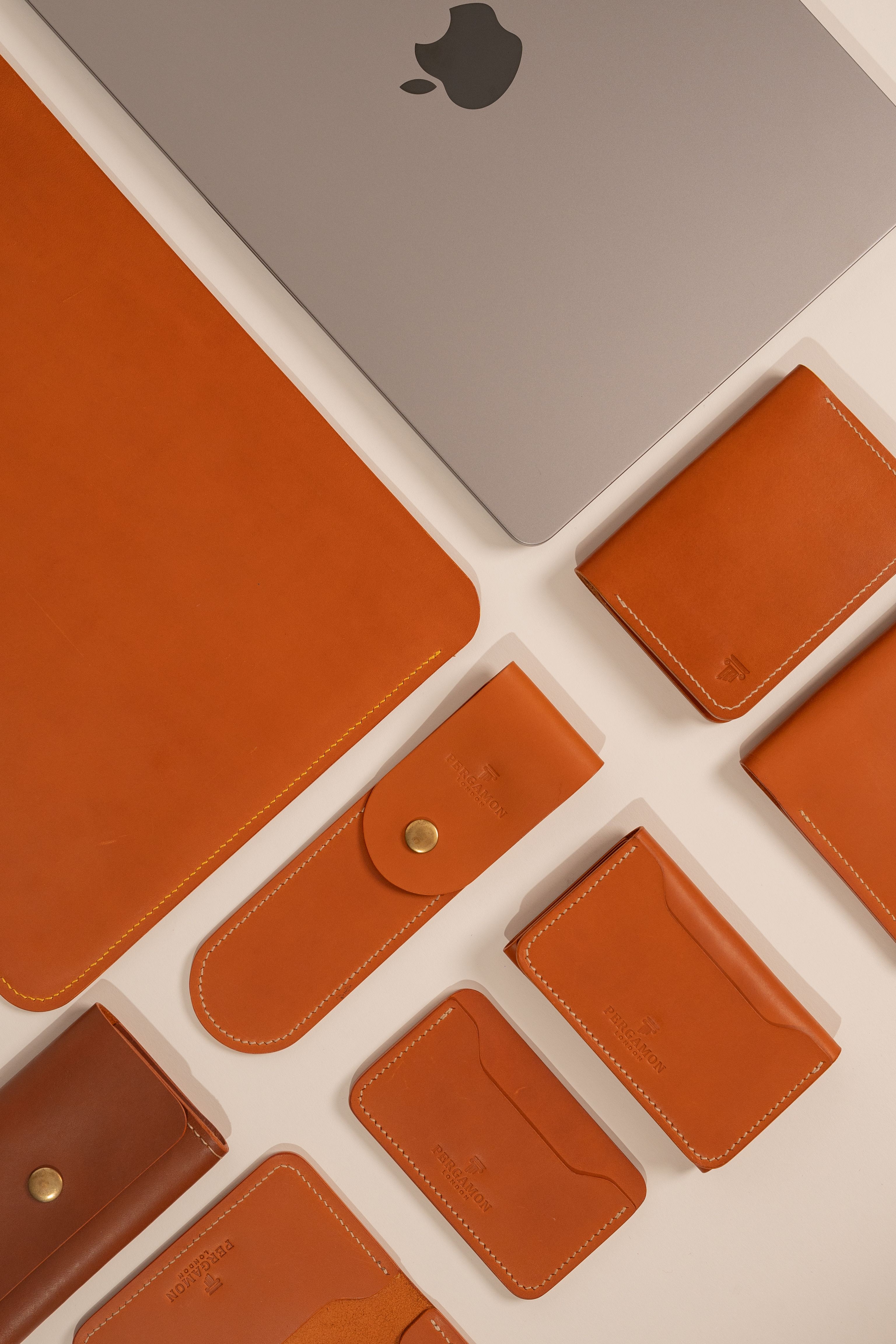 Stylish layout of leather accessories and a laptop, perfect for modern lifestyles.