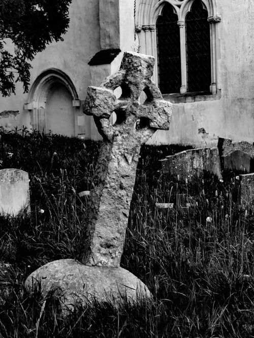 Free Black and white photo of an ancient churchyard with leaning gravestone. Stock Photo