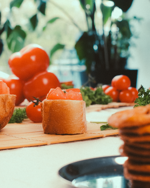 A glass bowl of canned diced tomatoes in their juice, showing firm uniform cubes next to an empty opened can