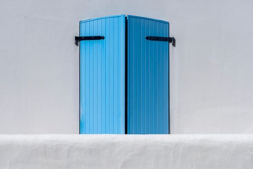 Free A minimalist photo featuring bright blue shutters on a clean, white wall, creating a striking color contrast. Stock Photo