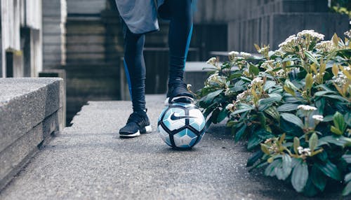 Person in Black Leggings Stepping on Nike Soccer Ball