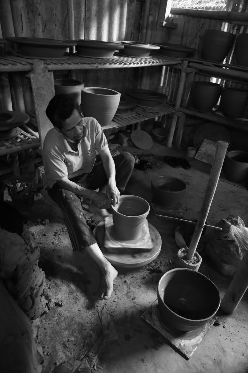 Free Artisan skillfully crafts clay pottery in a rustic workshop setting, showcasing traditional techniques. Stock Photo