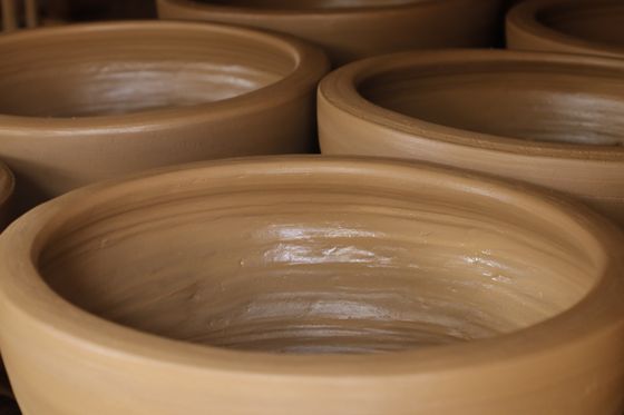 Close-up of an unglazed clay bowl, photo by Rian Andriani on Pexels