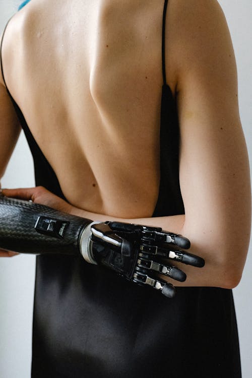 Woman in Black Slip Dress with Arms Crossed Behind Her Back