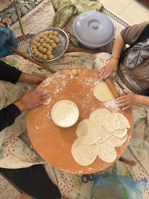 Free Two people making traditional flatbread in Muş, Türkiye, showcasing cultural culinary techniques. Stock Photo