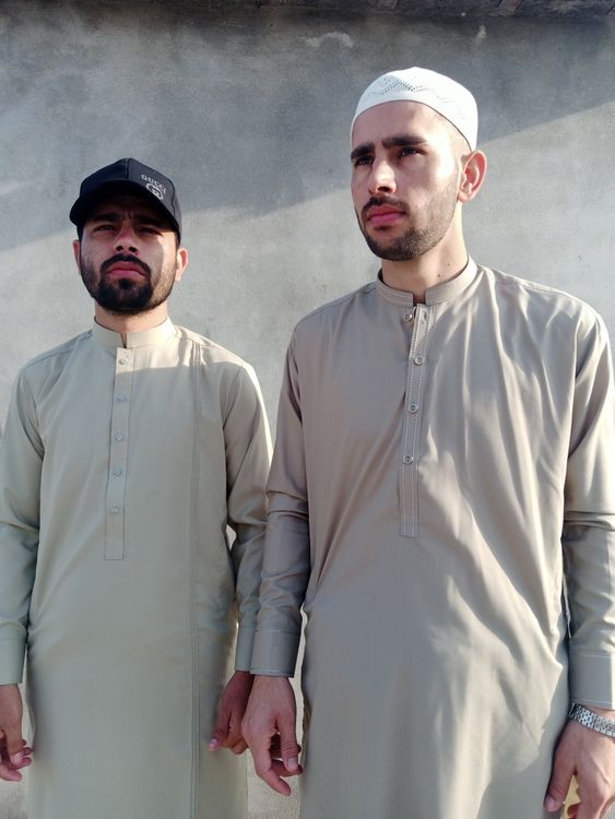 Two Men in Traditional Middle Eastern Attire Outdoors · Free Stock Photo