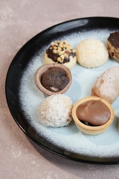 A selection of gourmet cookies elegantly arranged on a stylish black plate, perfect for dessert presentations.