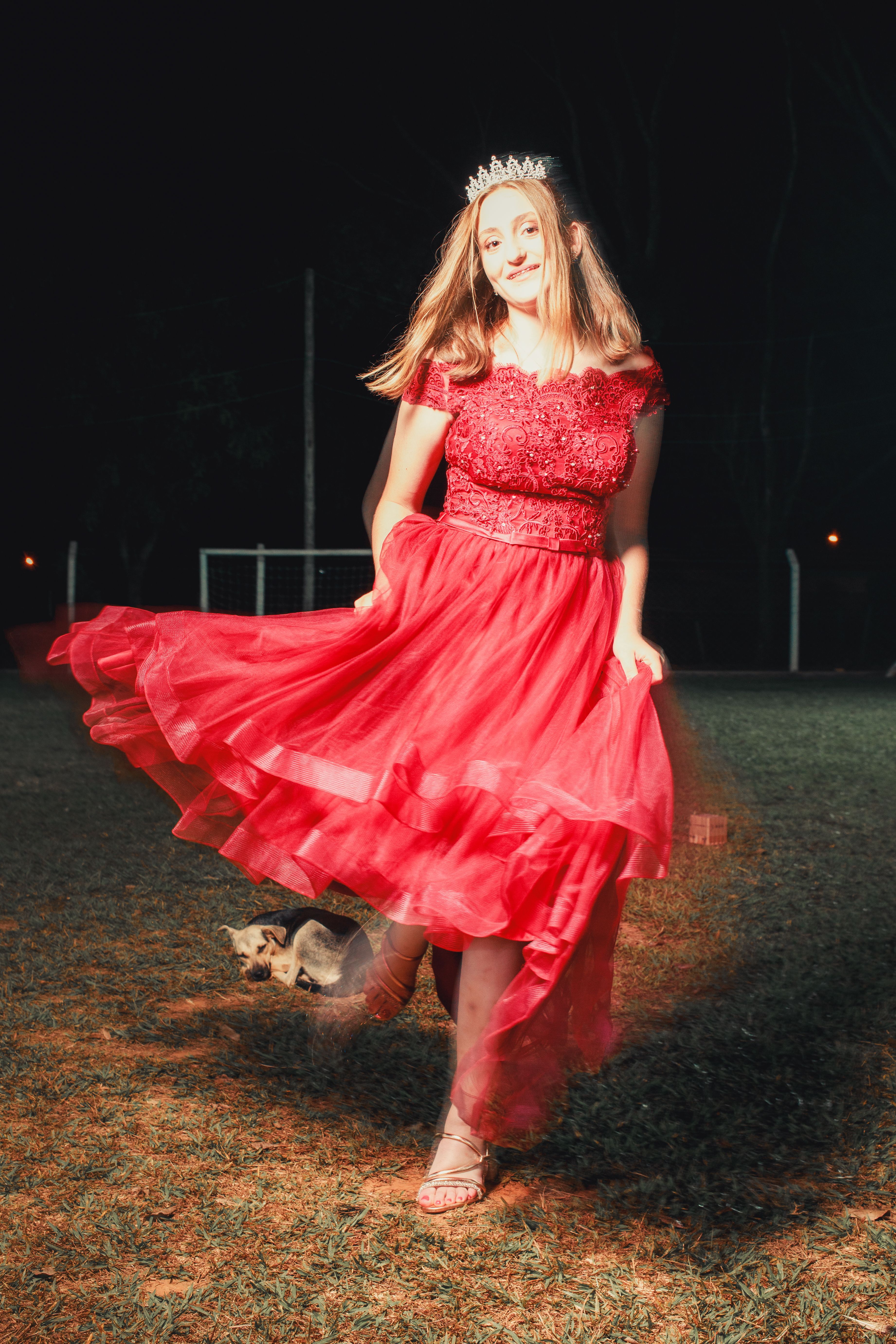 Young Woman Twirling in Red Dress at Night · Free Stock Photo