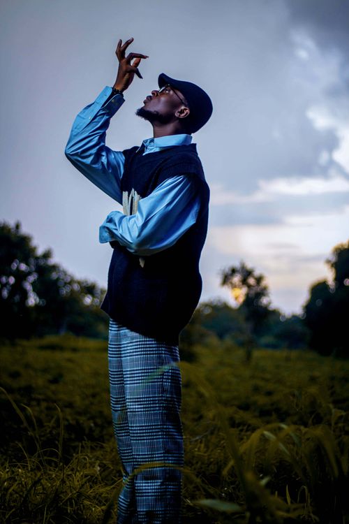 Free A stylish man in reflective pose outdoors during sunset. Stock Photo