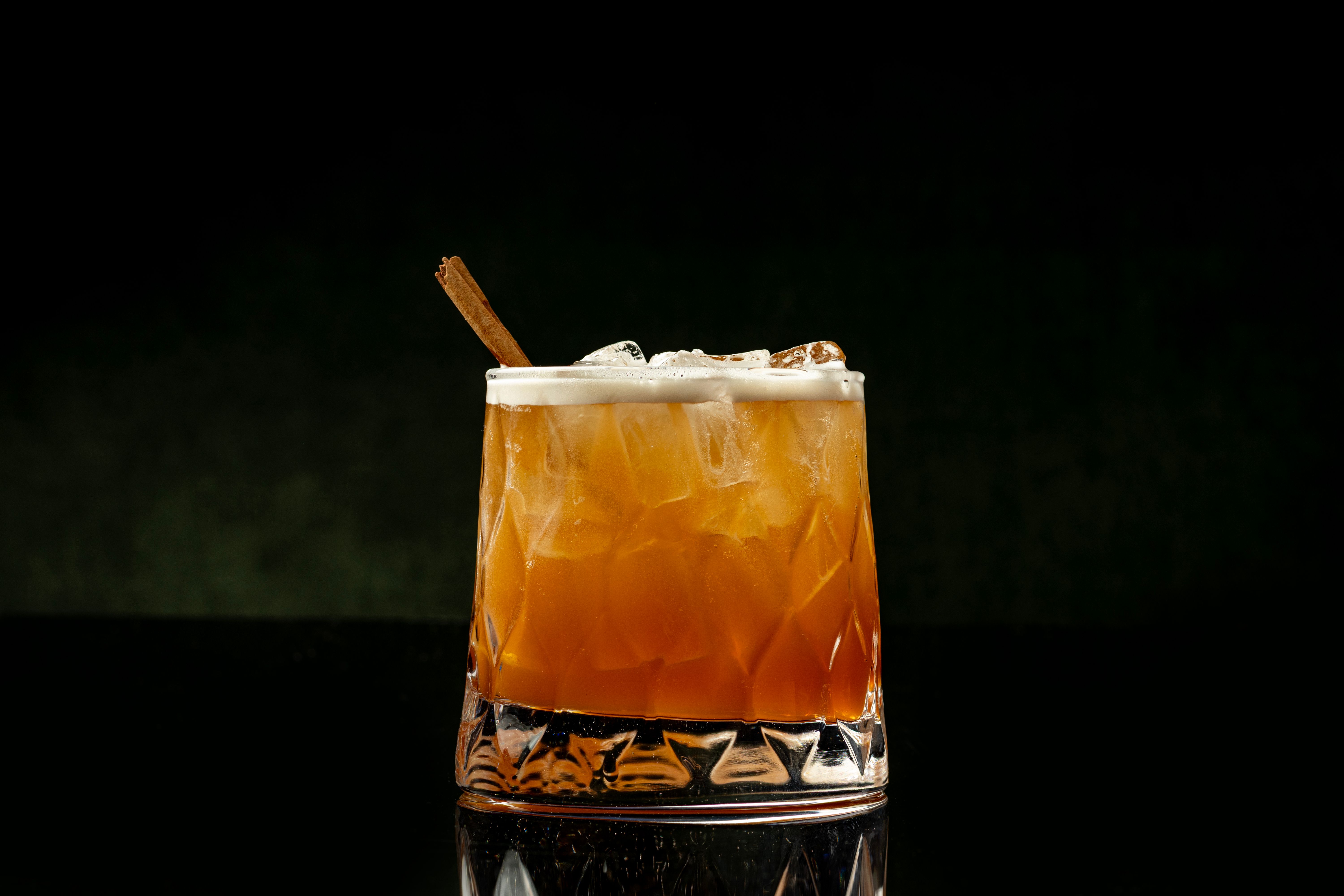 Smoked amber cocktail on a dark marble bar