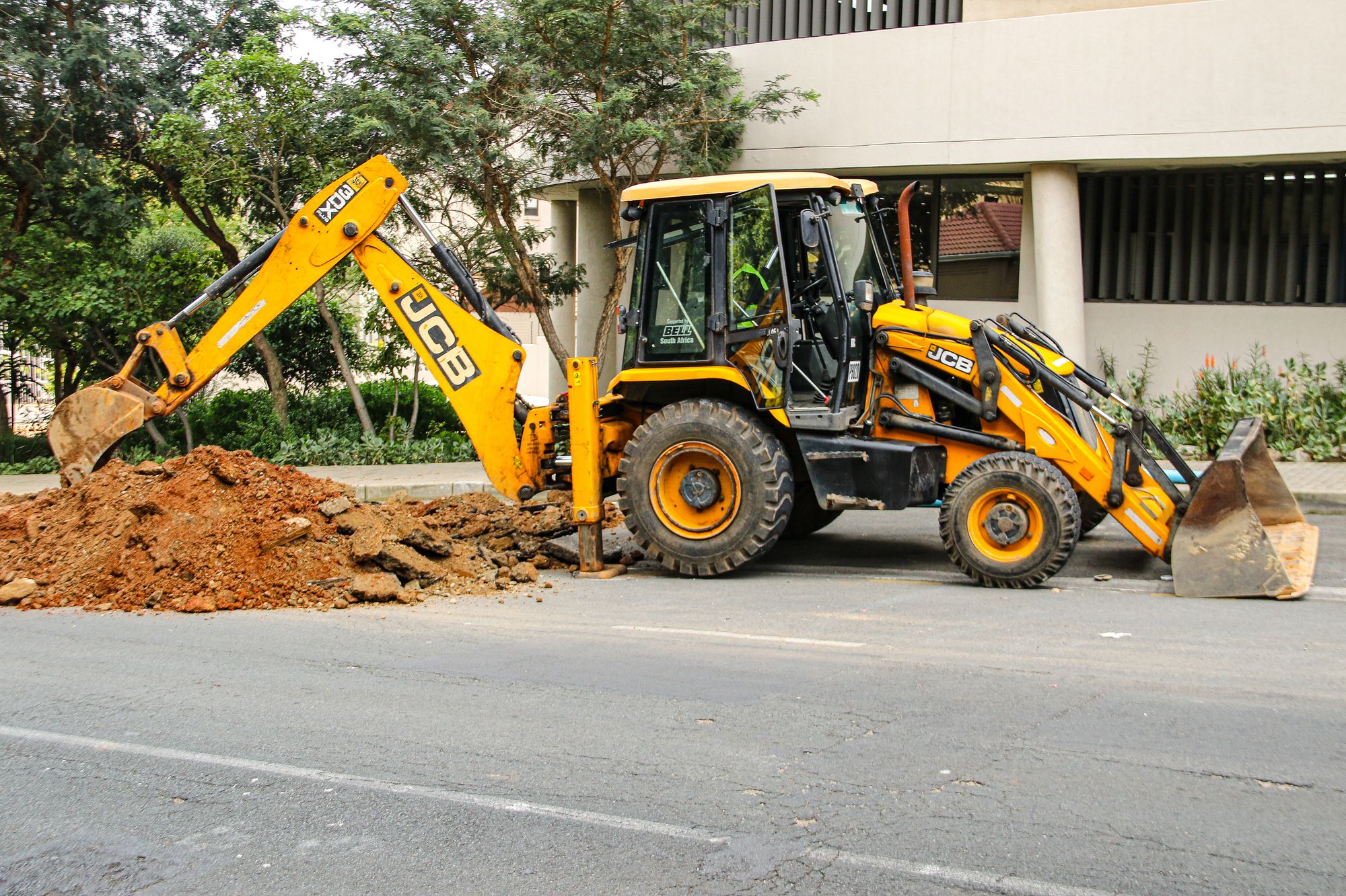 Excavator working on an urban construction site in Sandton