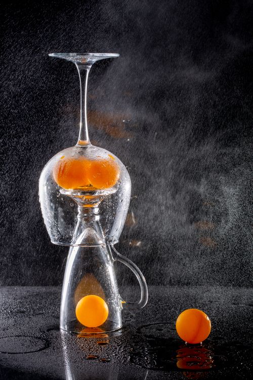 Free Artistic arrangement of glassware with vibrant oranges, perfect for modern decor. Stock Photo