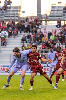 Players in a competitive soccer match, showcasing athletic skill and teamwork.