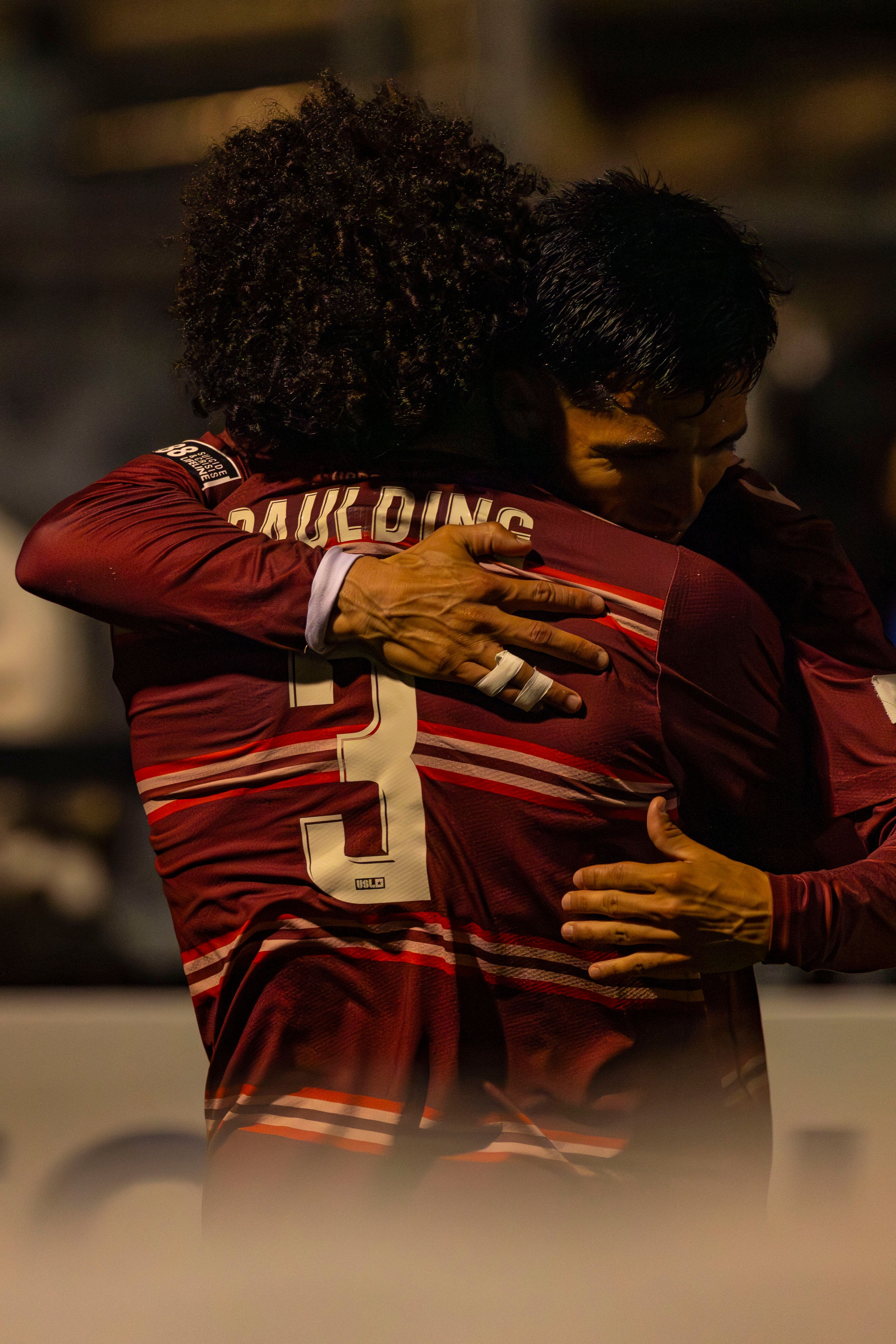 Celebratory Embrace Between Soccer Players