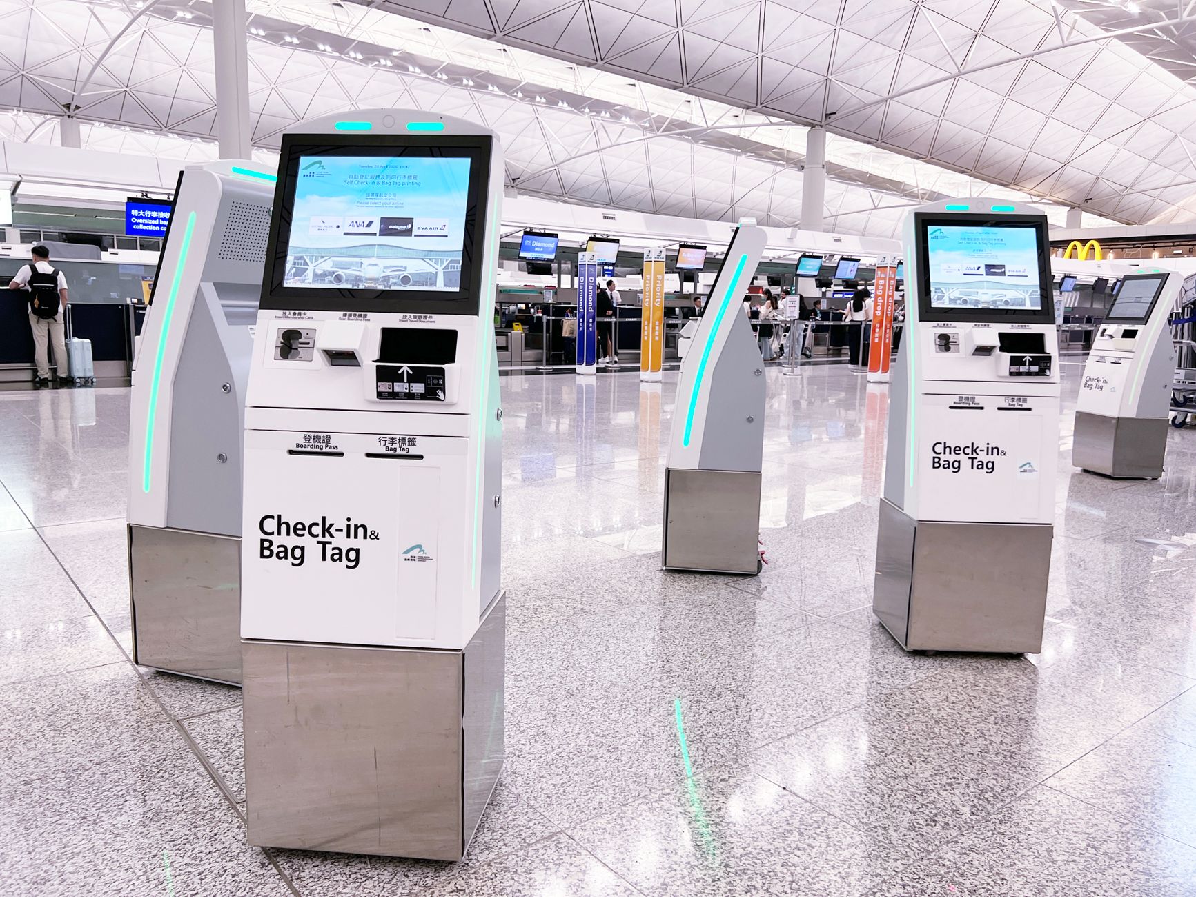 Modern check-in kiosks at Hong Kong International Airport's terminal. Efficient travel is enhanced by technology.