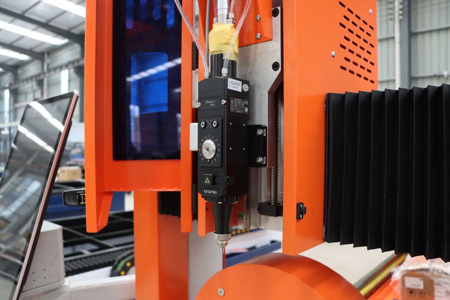 Multi-axis CNC machine head processing a complex component