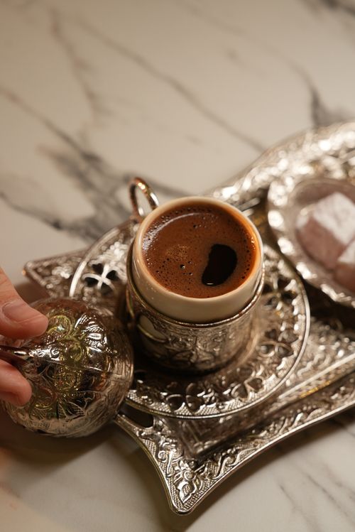 Free Elegant presentation of Turkish coffee with sweet Turkish delight on ornate tray Stock Photo
