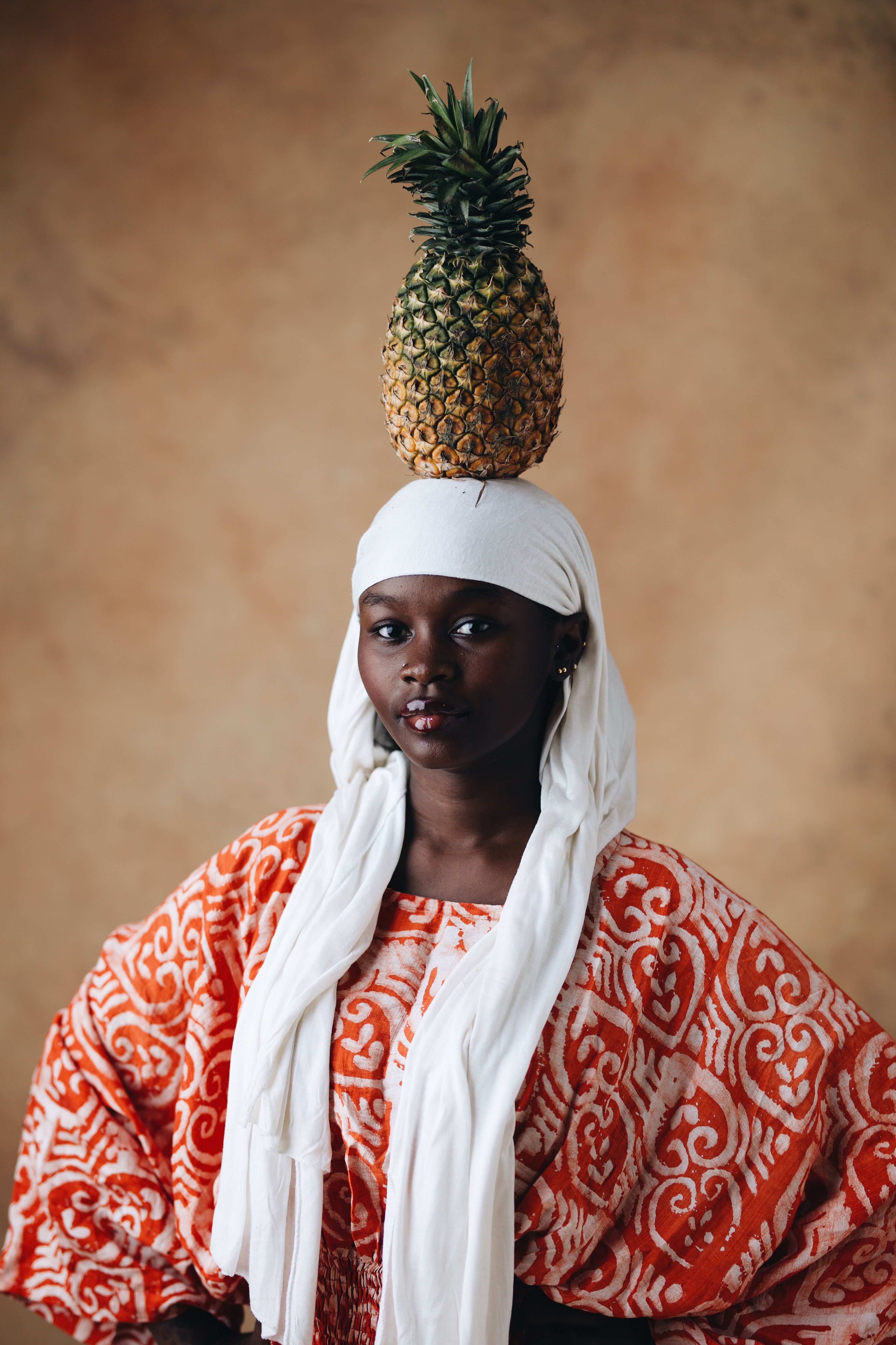 African Woman Balancing Pineapple Portrait · Free Stock Photo