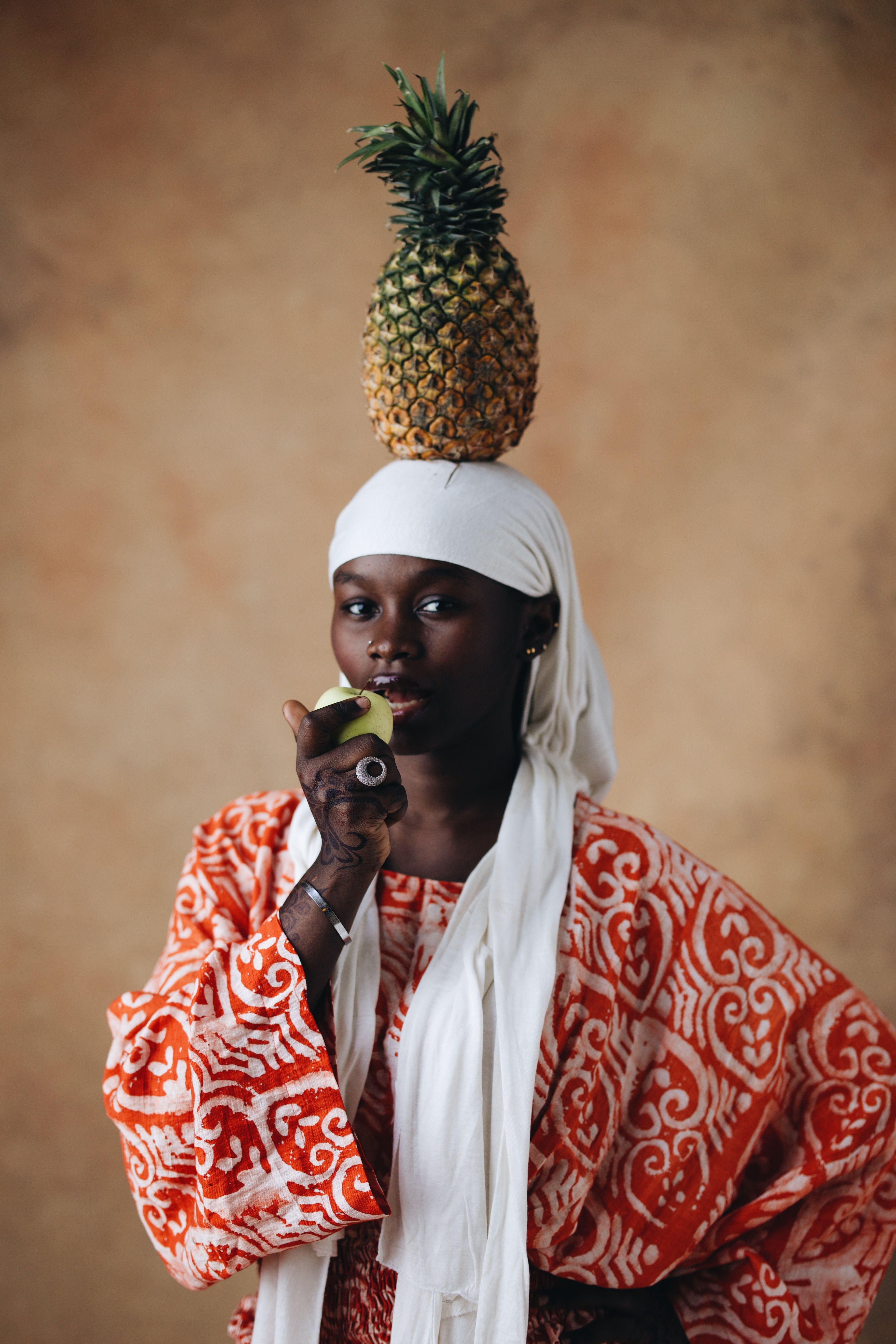 African Woman Balancing Pineapple Expressing Culture · Free Stock Photo