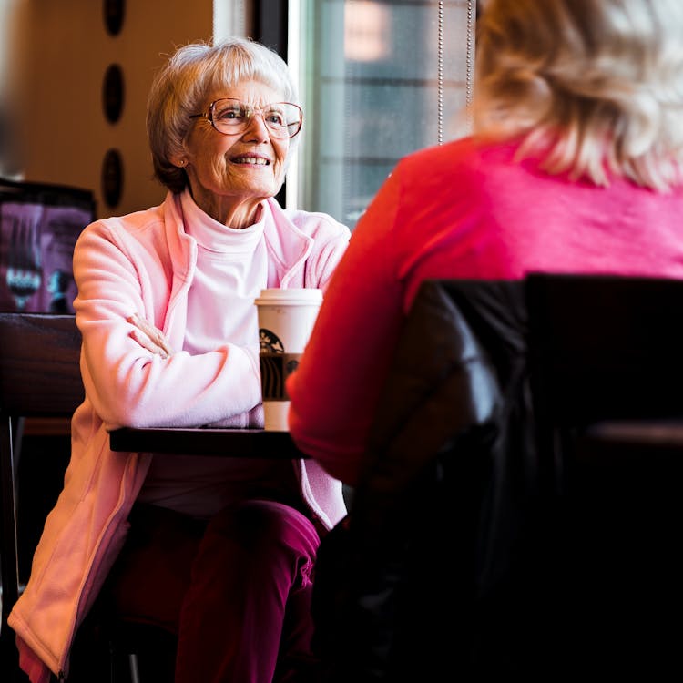 Senior Mother And Mature Daughter In Cafe