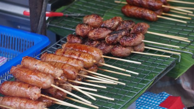 Delicious grilled sausage skewers on display at a street food stall in Chiang Mai, Thailand.