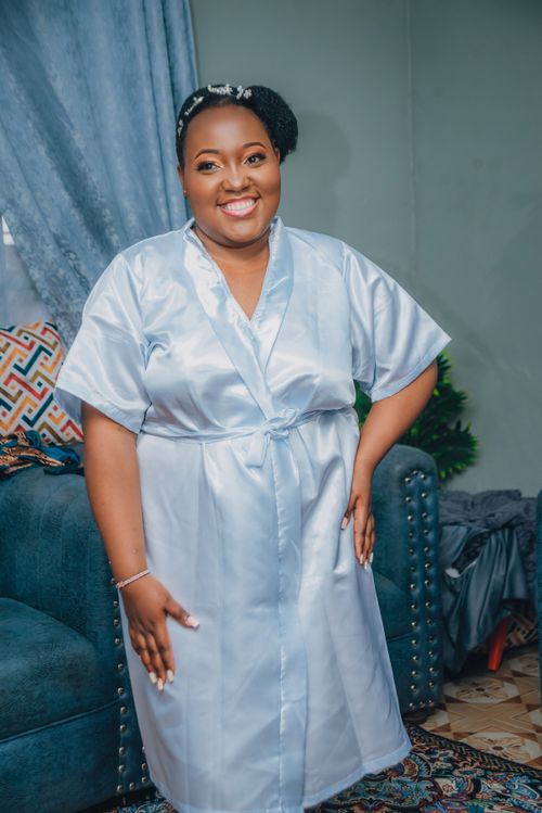 Free Happy bride in a silk robe getting ready for her wedding in Nairobi, Kenya. Stock Photo
