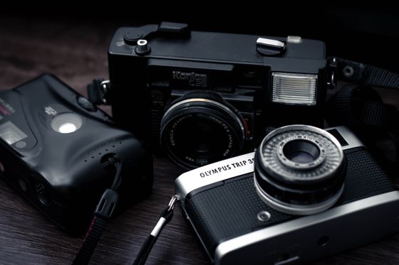 Olympus Trip 35 beside compact cameras