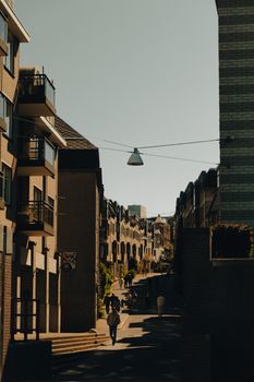 Moody urban street scene with shadows and architecture, perfect for city life themes.