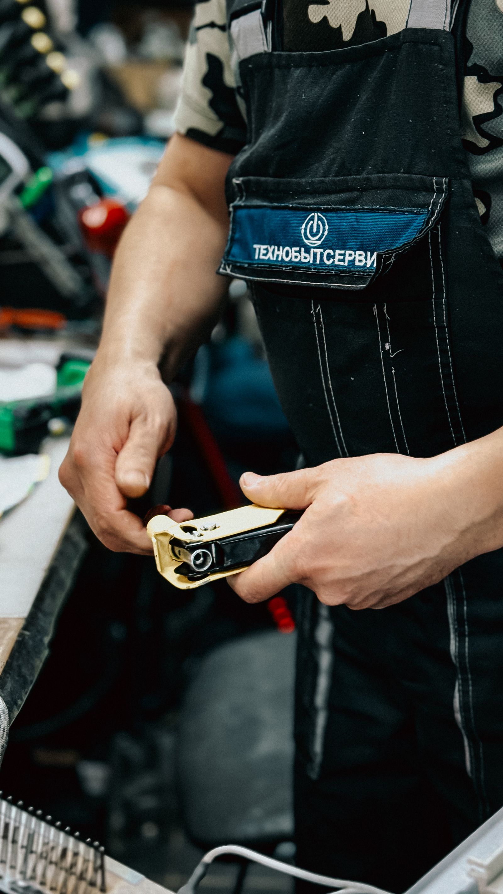 Worker using a plumbing tool in a workshop