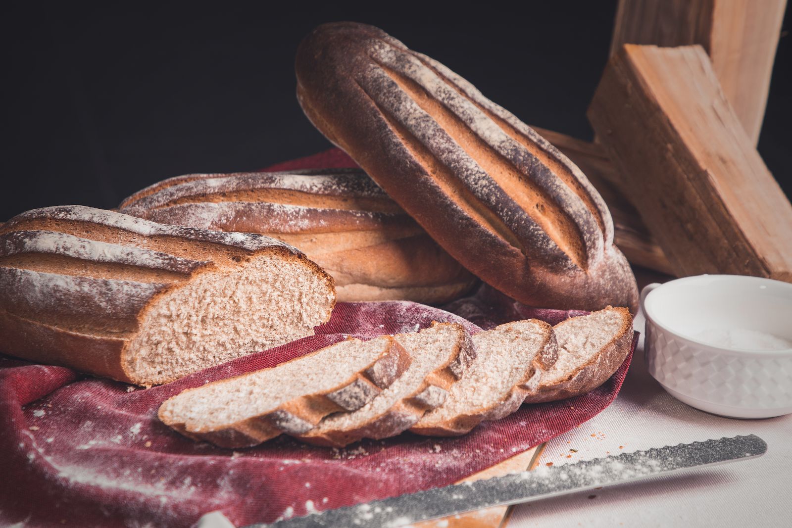 Sliced loaves of bread on a flour-dusted cloth