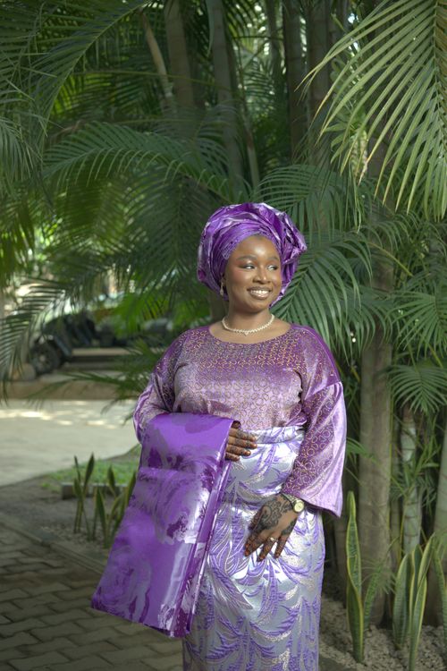 Free Woman in vibrant purple traditional Nigerian attire outdoors. Stock Photo