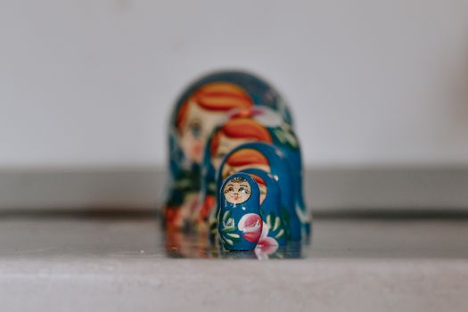 Close-up of colorful Russian nesting dolls in a line on a surface.