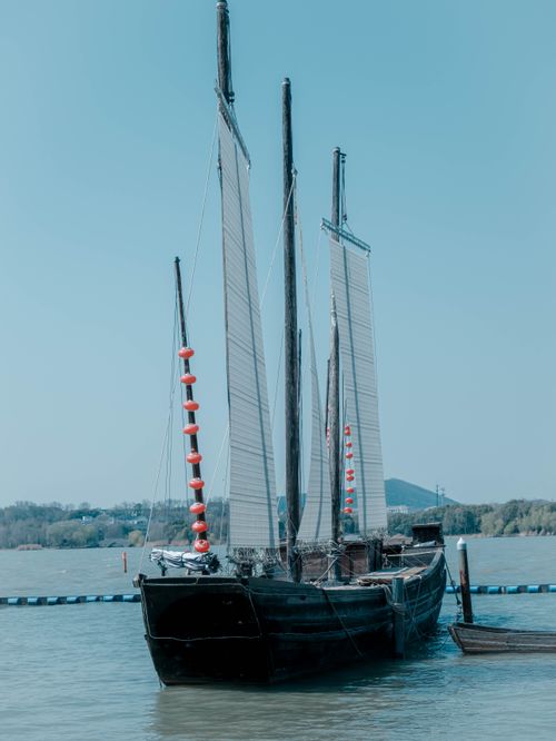 Free A vintage sailing ship moored on the lake, showcasing historical maritime craftsmanship. Stock Photo