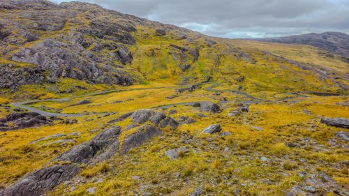 Free Breathtaking view of Irish mountain terrain with a winding road under cloudy skies, perfect for travel inspiration. Stock Photo