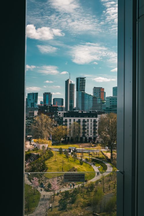 Free A breathtaking view of Vilnius cityscape, showcasing modern architecture and a vibrant park below. Stock Photo