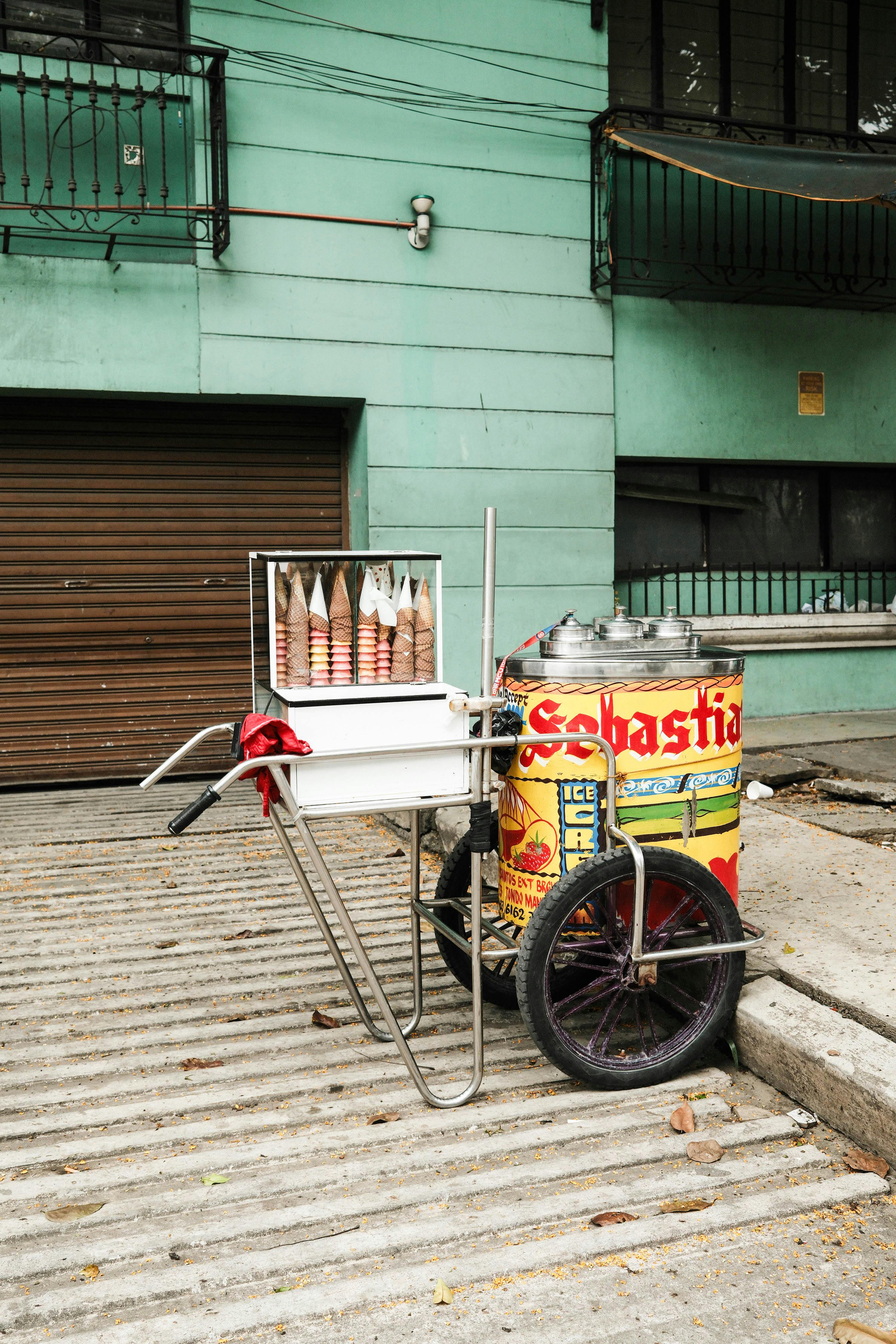 A classic street vendor's ice cream cart on a Manila sidewalk, showcasing local culture and charm.