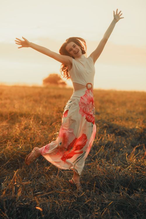 Joyful Woman Dancing in a Sunny Field · Free Stock Photo