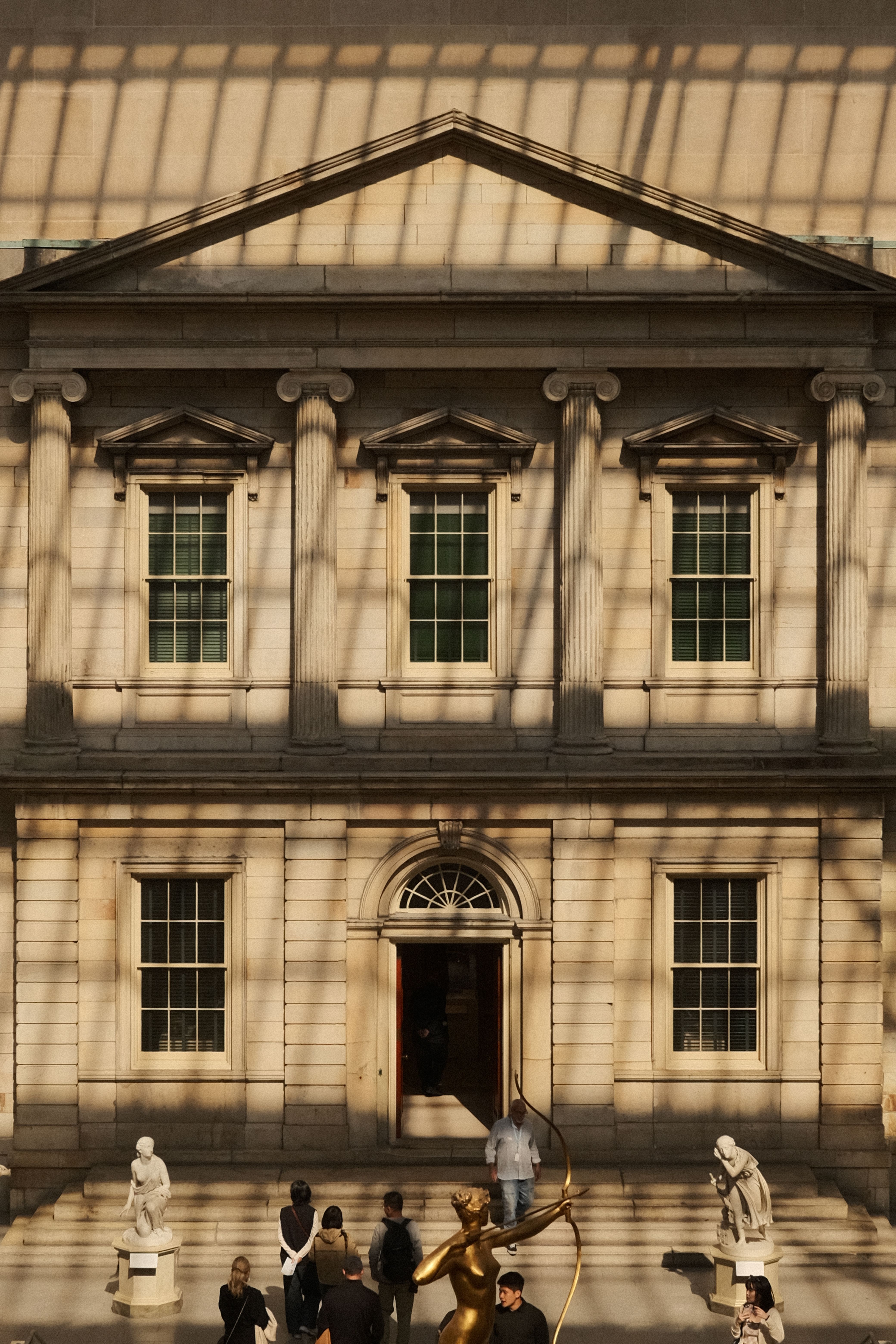 Classical Architecture with Sculptures in Sunlit Atrium · Free Stock Photo